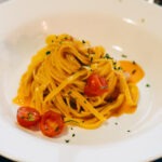 Two-Tomato calamarata: A Mediterranean Pasta Recipe with Sun-Dried Tomatoes and Capers